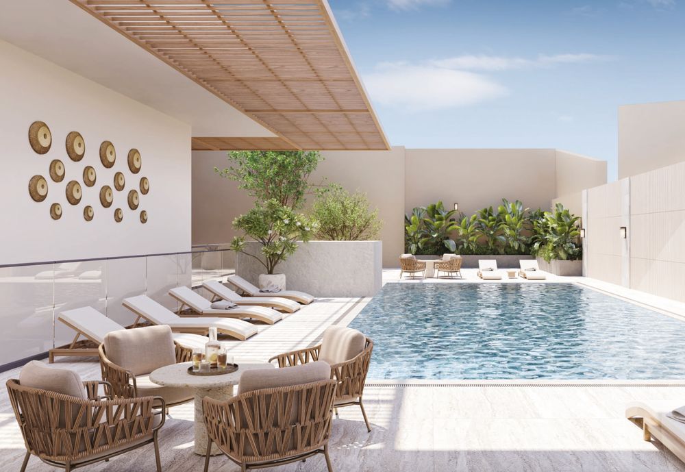 Swimming pool deck with loungers and shaded seating, Al Aamra 3 Tower brochure image